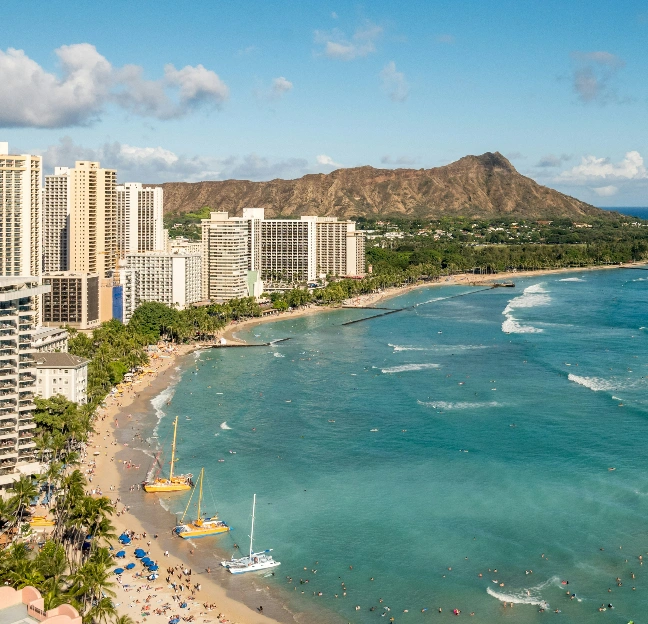 Aerial view of a crowded beach and hotels facing the ocean
