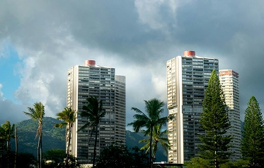 the clouds are clearing and building is visible