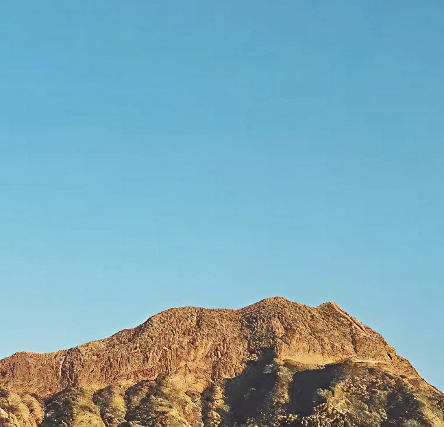 rugged desert mountain under blue sky
